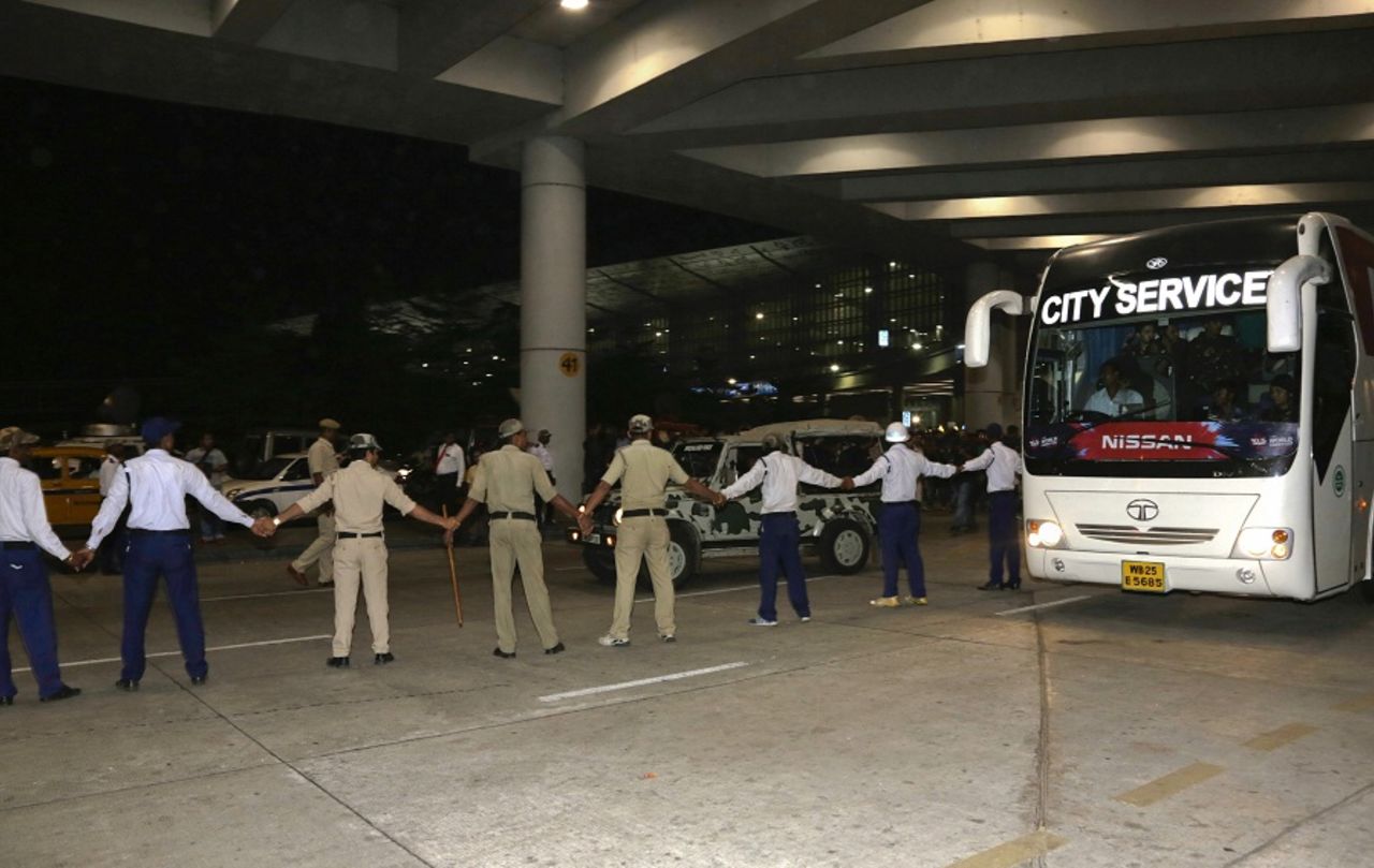 Security personnel form a barricade around the Pakistan team bus at the Kolkata airport, March 12, 2016