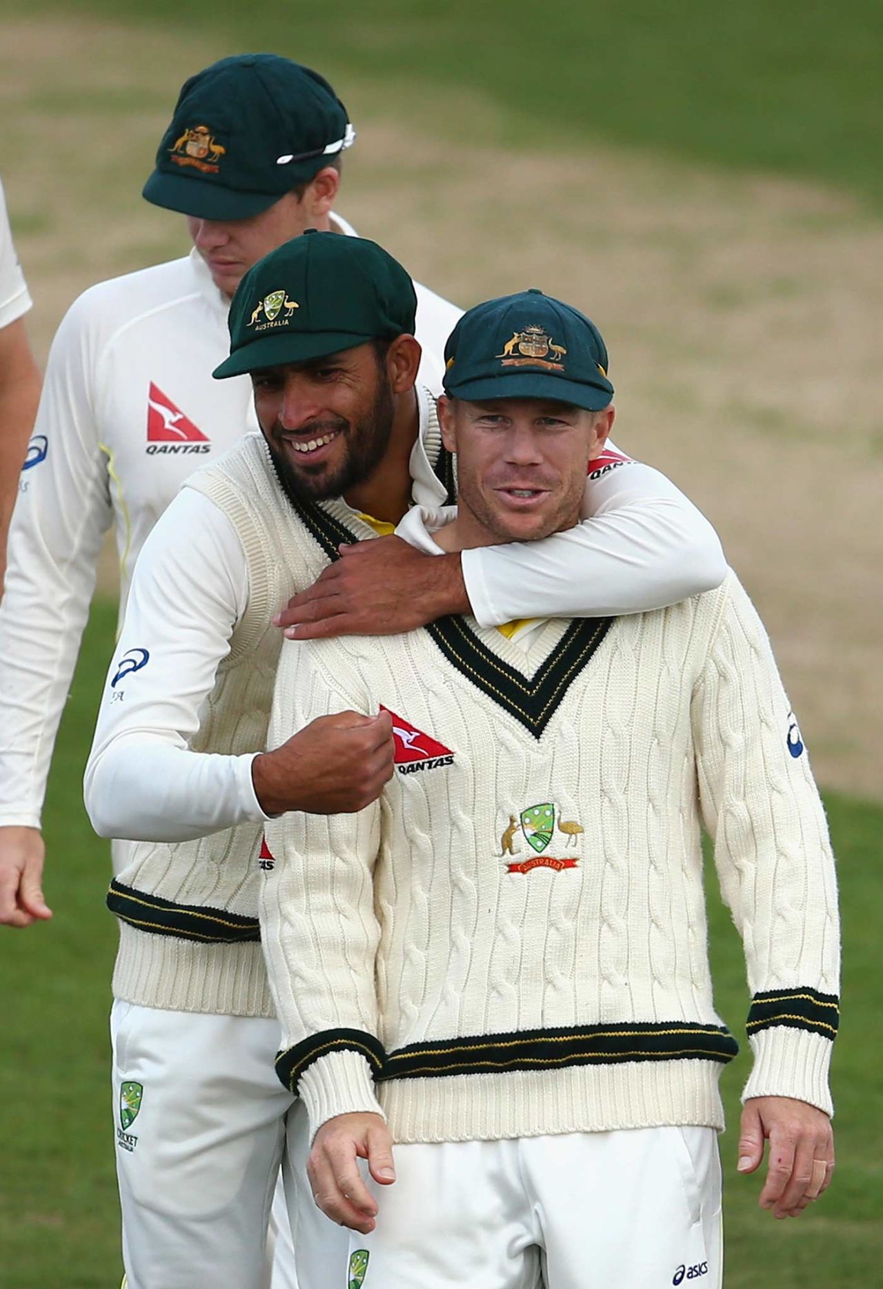 Fawad Ahmed puts his arm around David Warner as they leave the field, Northamptonshire v Australians, day two, Northampton, August 15, 2015