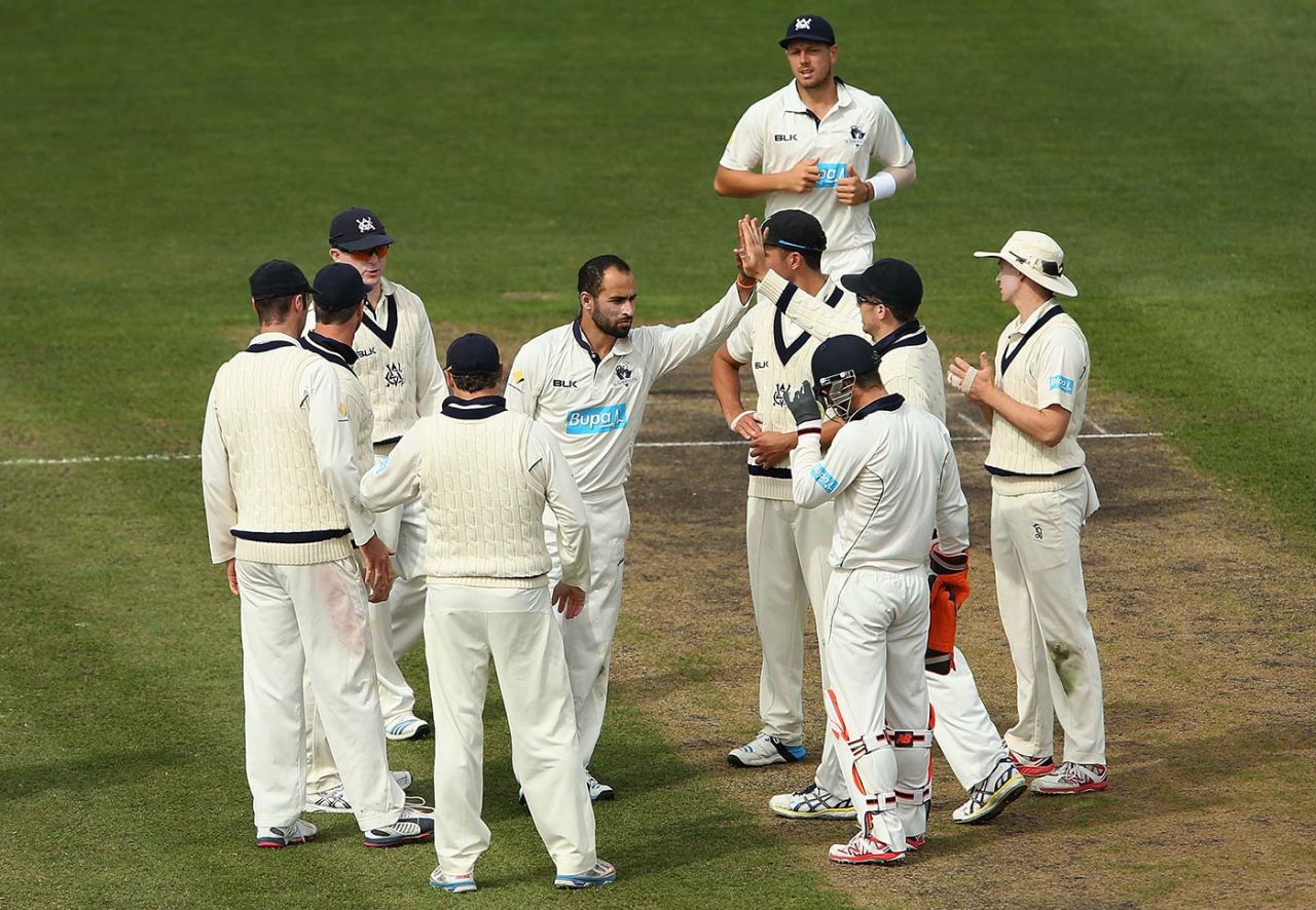 Fawad Ahmed is congratulated after he takes the wicket of Sam Whiteman, Victoria v Western Australia, Sheffield Shield final, day two, Hobart, March 22, 2015