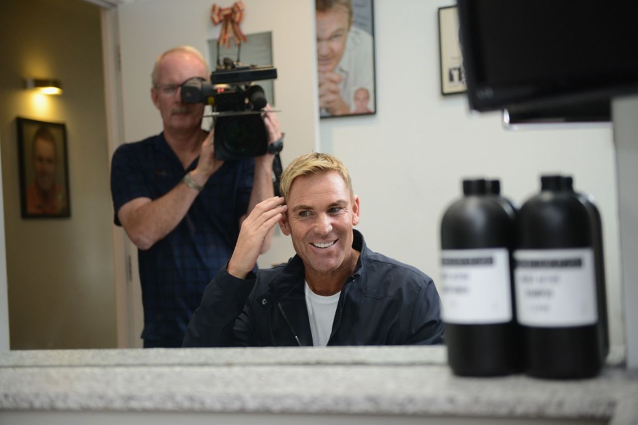 Shane Warne checks out his hairdo at a promotional event in Melbourne, Melbourne, March 18, 2016