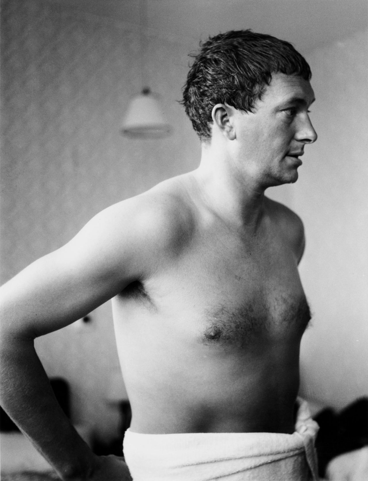 Richie Benaud stands in a towel in his hotel room, June 5, 1961