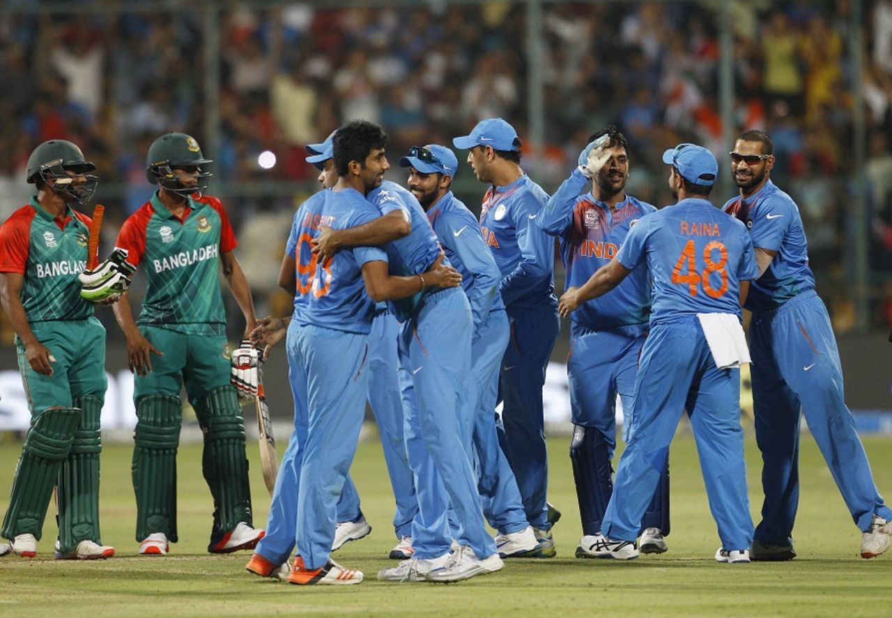 India players celebrate their close win while Shuvagata Hom and Mustafizur Rahman look on, India v Bangladesh, World T20 2016, Group 2, Bangalore, March 23, 2016