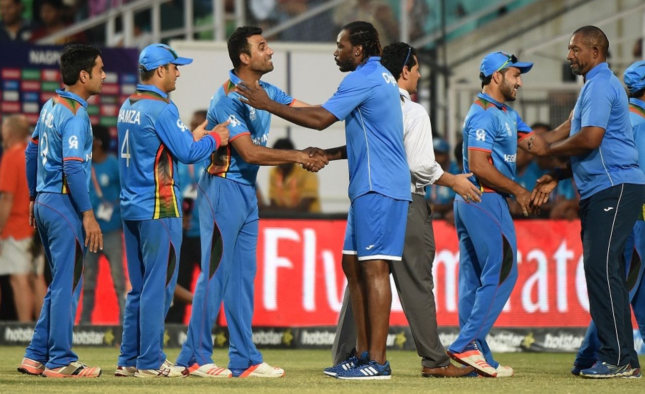 Chris Gayle and Phil Simmons congratulate the Afghanistan players after their win, Afghanistan v West Indies, World T20 2016, Group 1, Nagpur, March 27, 2016