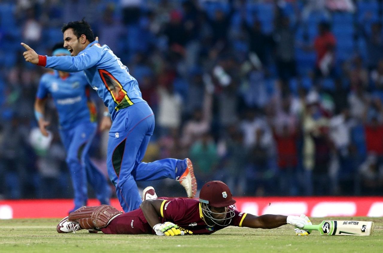 Samiullah Shenwari celebrates after Andre Russell is run out, Afghanistan v West Indies, World T20 2016, Group 1, Nagpur, March 27, 2016