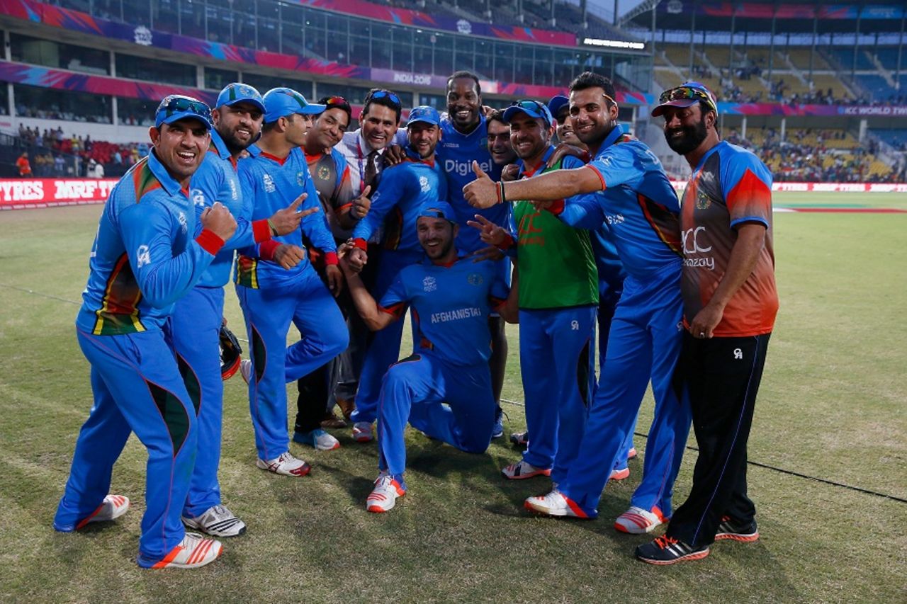 Chris Gayle poses with the Afghanistan players after the match, Afghanistan v West Indies, World T20 2016, Group 1, Nagpur, March 27, 2016