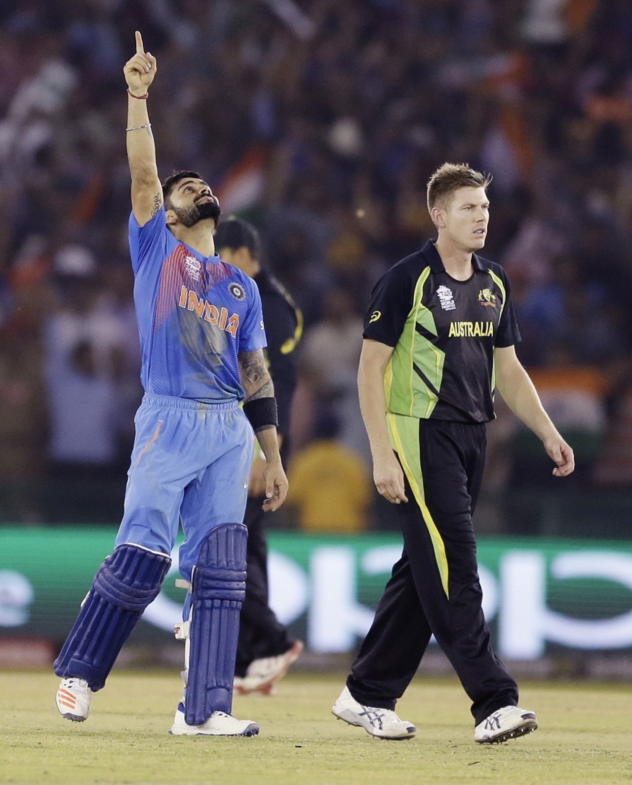 Virat Kohli celebrates after sealing yet another chase for India, while James Faulkner looks dejected, Australia v India, World T20 2016, Group 2, Mohali, March 27, 2016