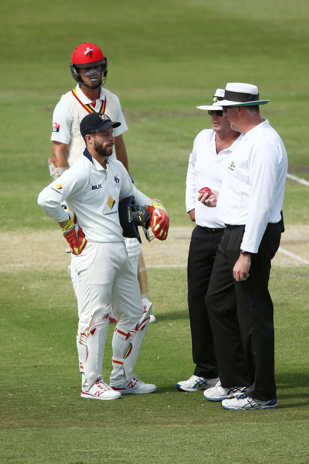 The on-field umpires talk to Matthew Wade before penalising Victoria for ball tampering, South Australia v Victoria, Sheffield Shield Final, Adelaide, third day, March 28, 2016