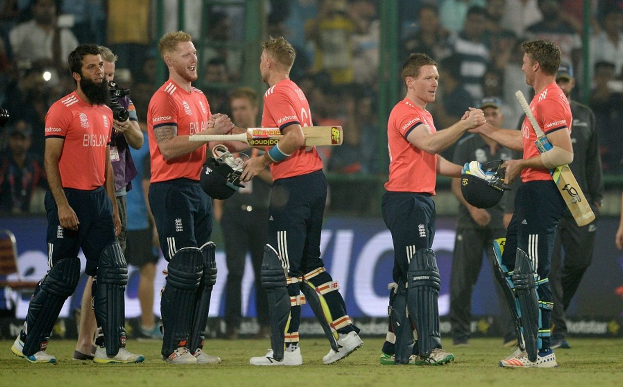 The England team line up to congratulate Joe Root and Jos Buttler after the win, England v New Zealand, World T20, Semi-final, Delhi, March 30, 2016