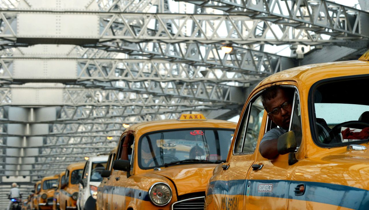 Taxis wait in heavy traffic on Howrah Bridge in Kolkata, November 7, 2014