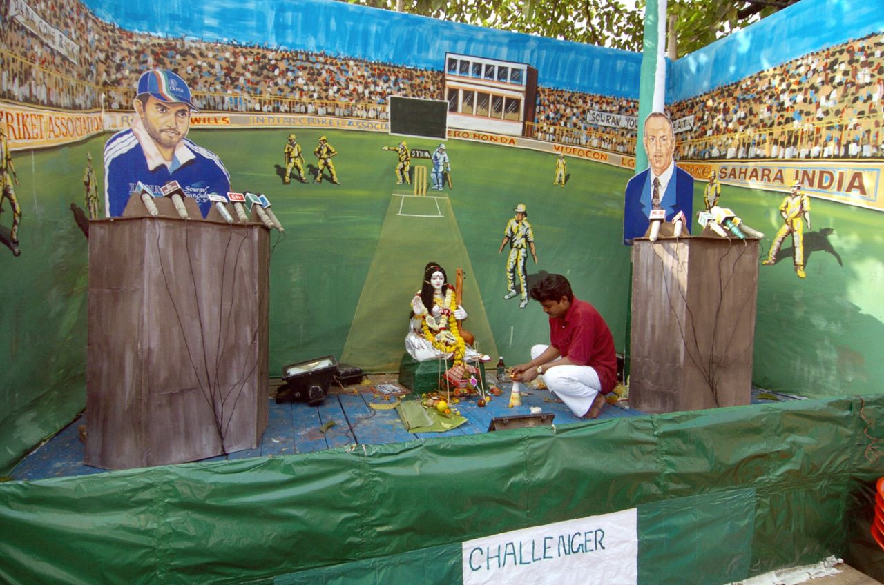 Cutouts of Sourav Ganguly and Ian Chappell flank a Hindu idol on a stage in Kolkata, February 4, 2006