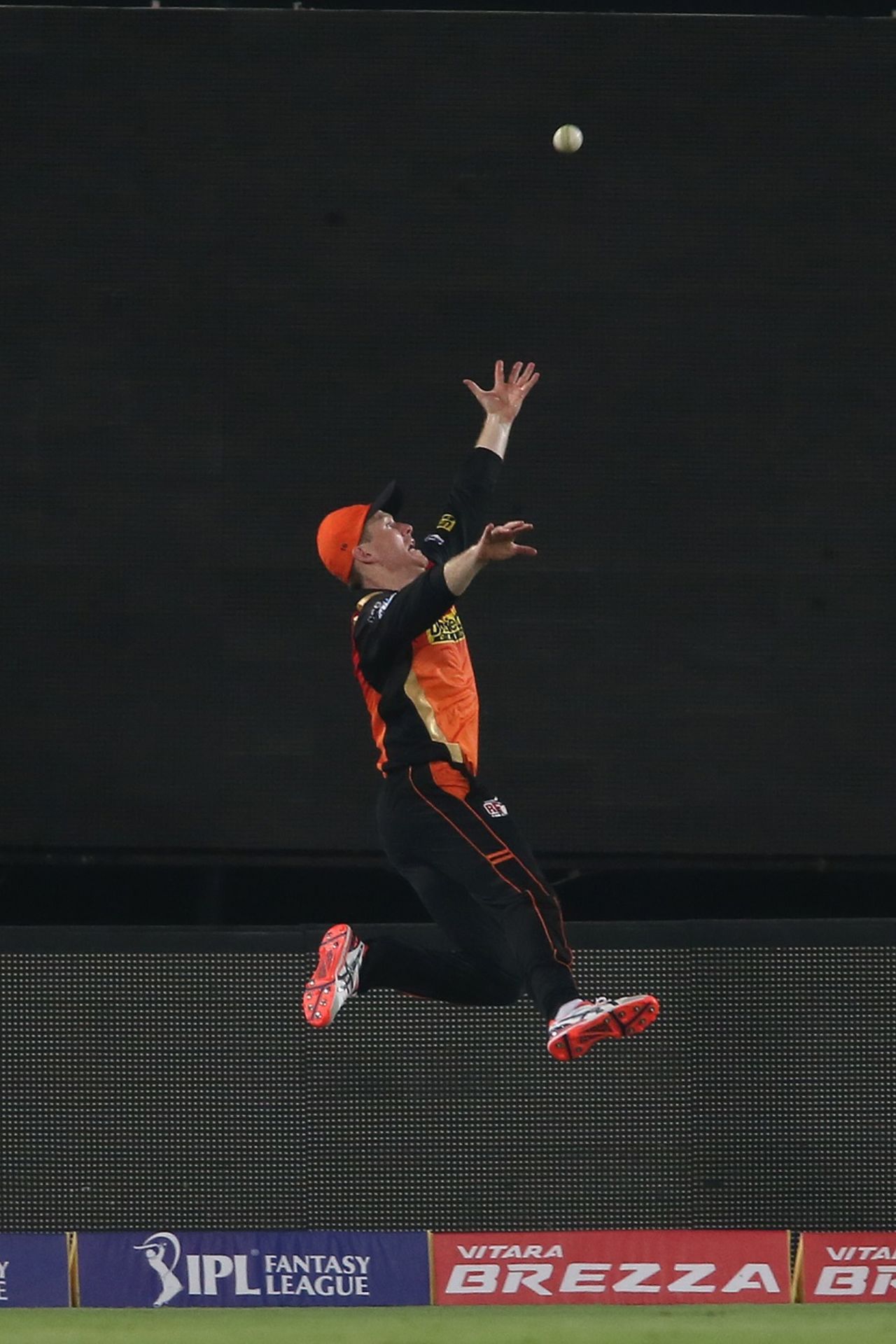 Eoin Morgan jumps up with outstretched hands in a bid to prevent a six, Sunrisers Hyderabad v Mumbai Indians, IPL 2016, Hyderabad, April 18, 2016
