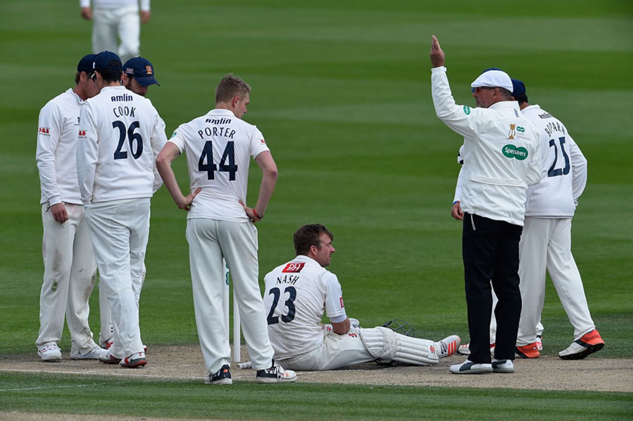 The Essex players and the umpires check on Chris Nash, Sussex v Essex, County Championship, Division Two, Hove, 3rd day, April 19, 2016