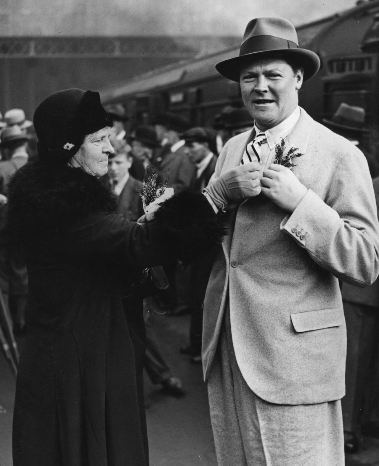 England captain Percy Chapman receives a sprig of "lucky" heather from his mother before leaving for the tour of South Africa, October 16, 1930