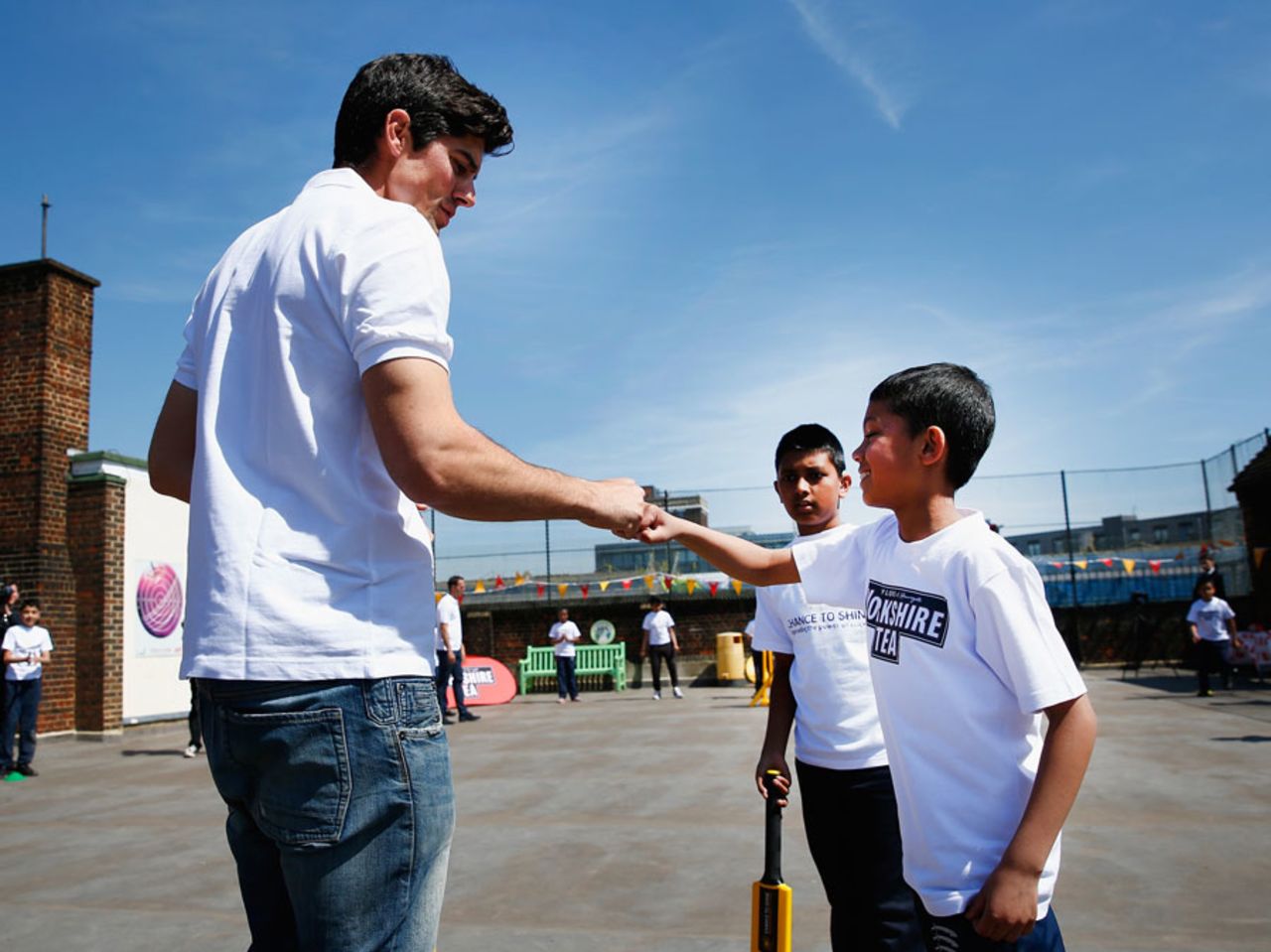 Alastair Cook gets a fist bump at a Chance to Shine event in Bethnal Green, London, May 5, 2016
