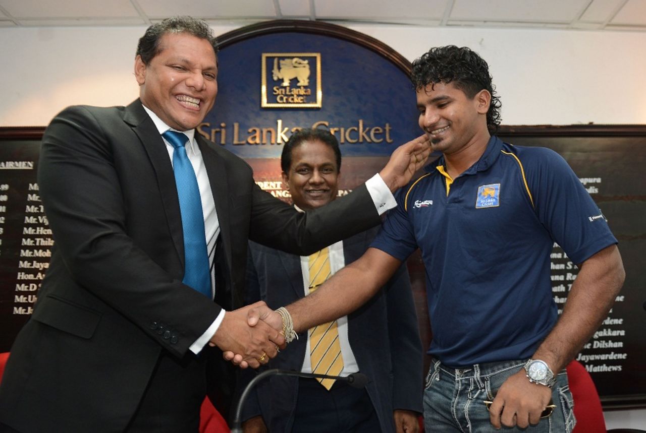 Kusal Perera shakes hands with Sri Lanka's sports minister Dayasiri Jayasekara, Colombo, May 12, 2016