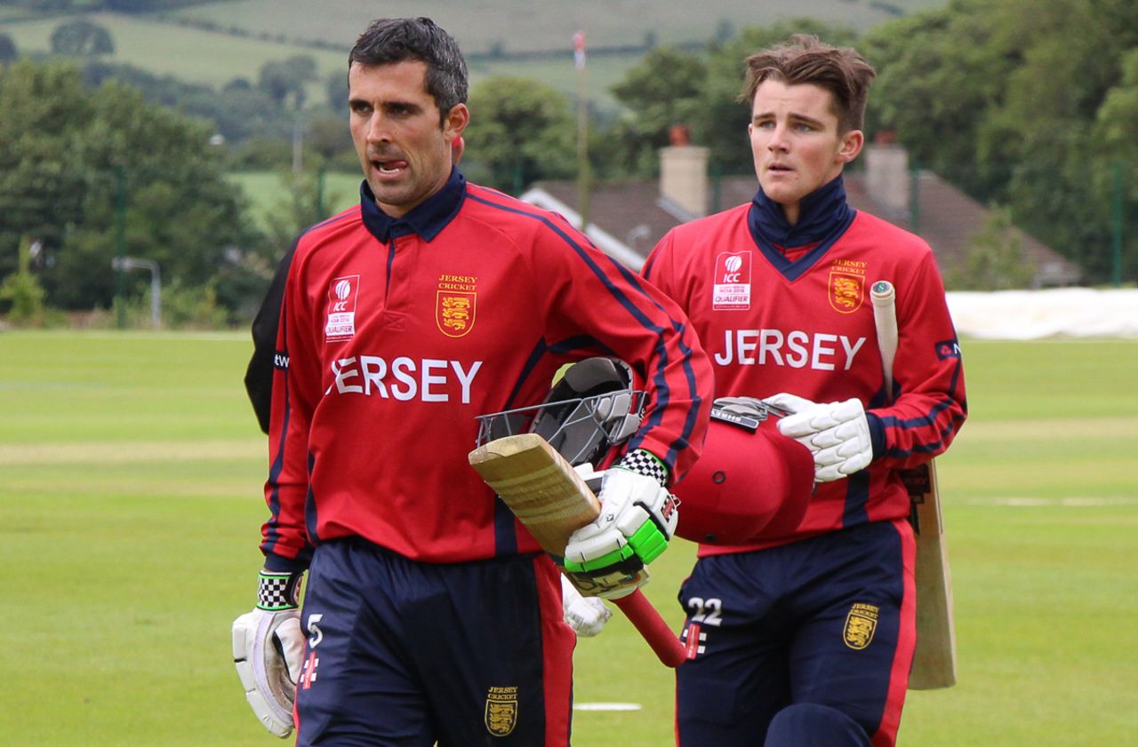 Jersey captain Peter Gough leads team-mate Jonty Jenner off the field after notching victory, Hong Kong v Jersey, World T20 Qualifier, Bready, July 11, 2015