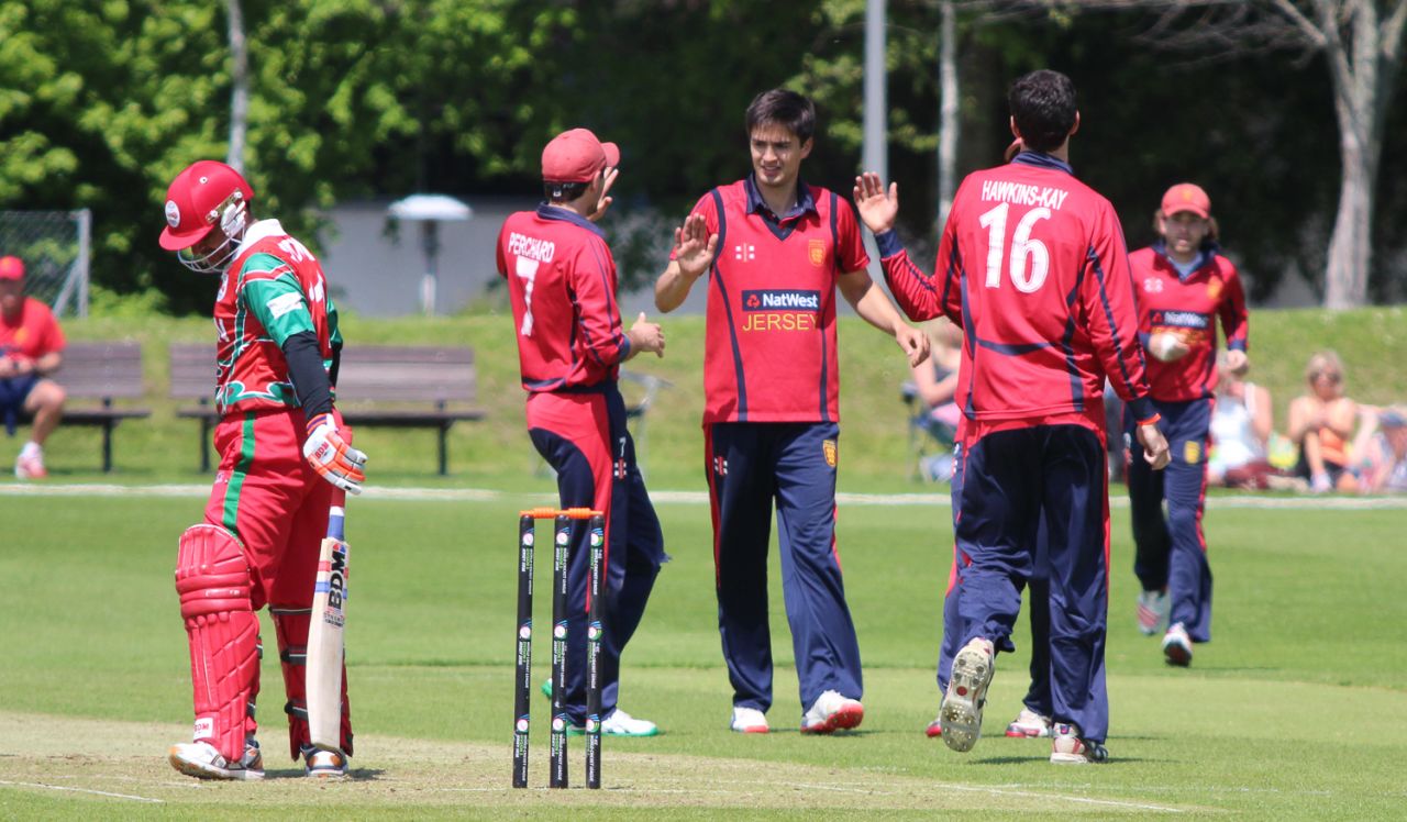 Ben Stevens is congratulated after taking the wicket of Zeeshan Siddiqui, Jersey v Oman, ICC World Cricket League Division Five, St Saviour, May 23, 2016 