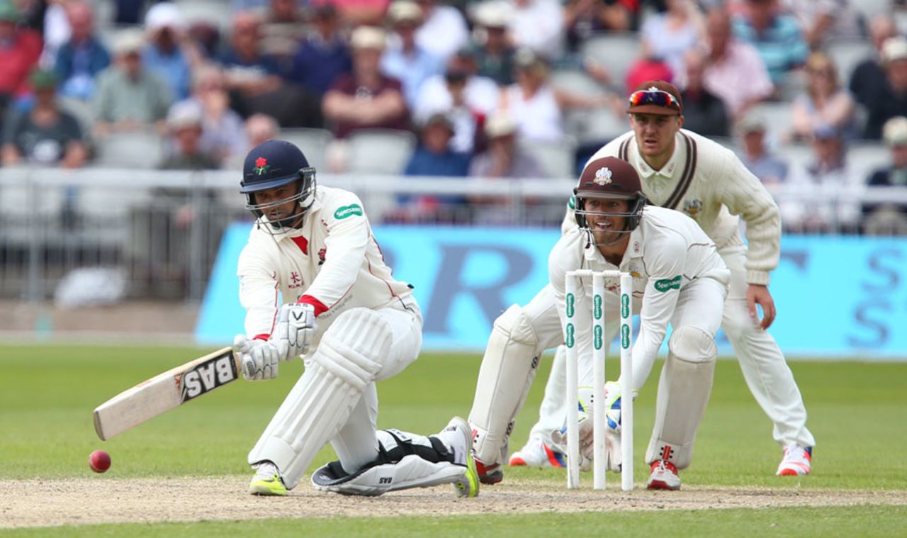Alviro Petersen gets down low to sweep, Lancashire v Surrey, County Championship, Division One, Old Trafford, 2nd day, May 23, 3016