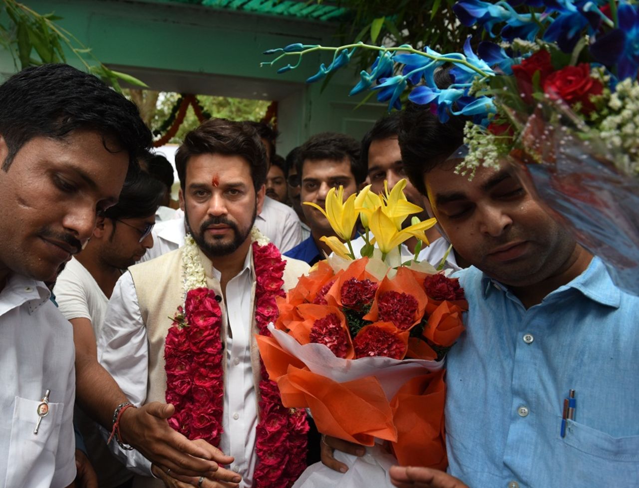 BCCI president Anurag Thakur is mobbed by his supporters at his residence in New Delhi, May 23, 2016