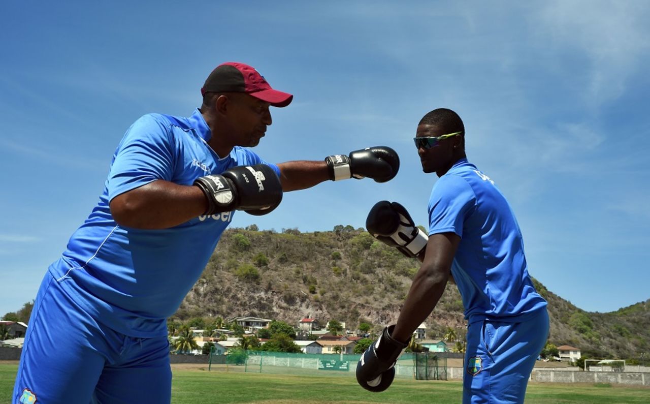 Put 'em up: West Indies coach Phil Simmons boxes with captain Jason Holder, Basseterre, June 10, 2016