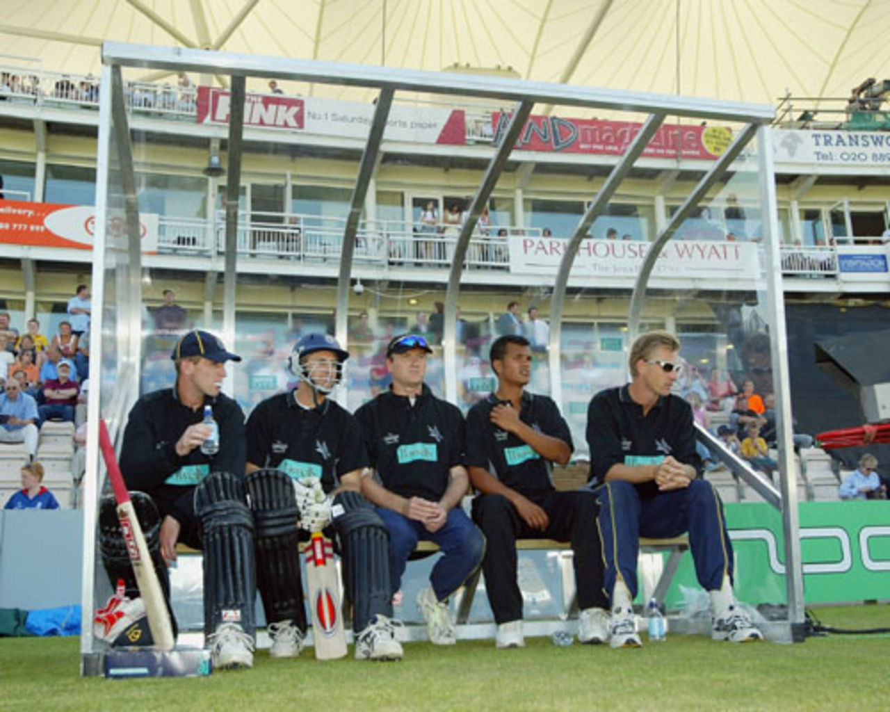 Hampshire players John Crawley, Simon Katich, Shaun Udal, Lawrence Prittipaul and Alan Mullally wait in the dugout during the Twenty20 Cup match between Hampshire and Sussex, Southampton, June 13, 2003 
