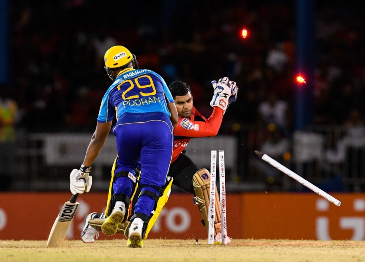 Umar Akmal takes the bails off as Nicholas Pooran is caught short of his crease, Trinbago Knight Riders v Barbados Tridents, CPL 2016, Port-of-Spain, July 1, 2016 