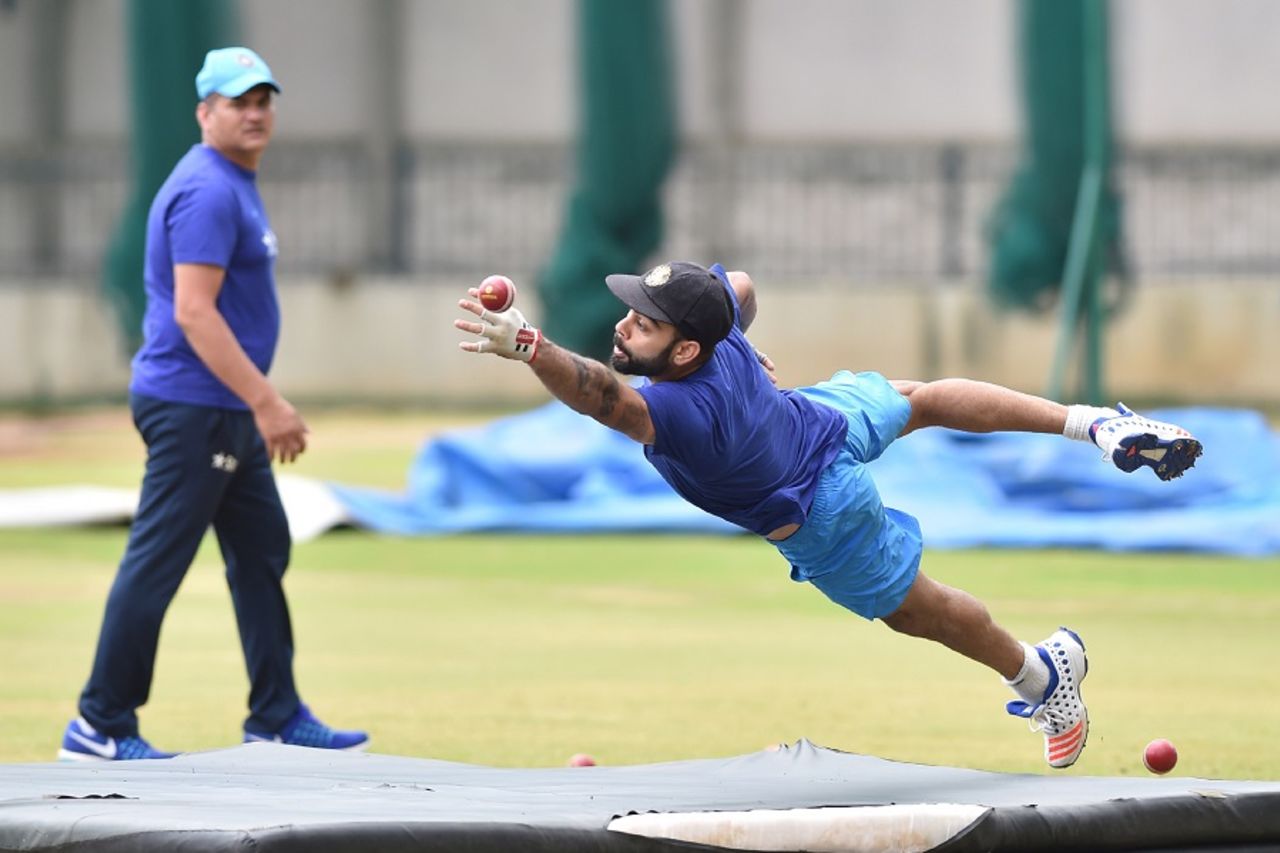 Virat Kohli dives as he tries to take a catch during the Indian team's training camp at the National Cricket Academy, Bangalore, July 4, 2016
