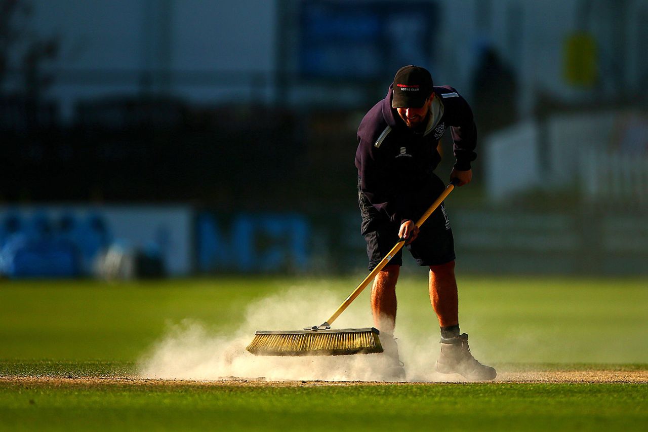 A groundsman sweeps the dust off the pitch, Hove, May 4, 2016
