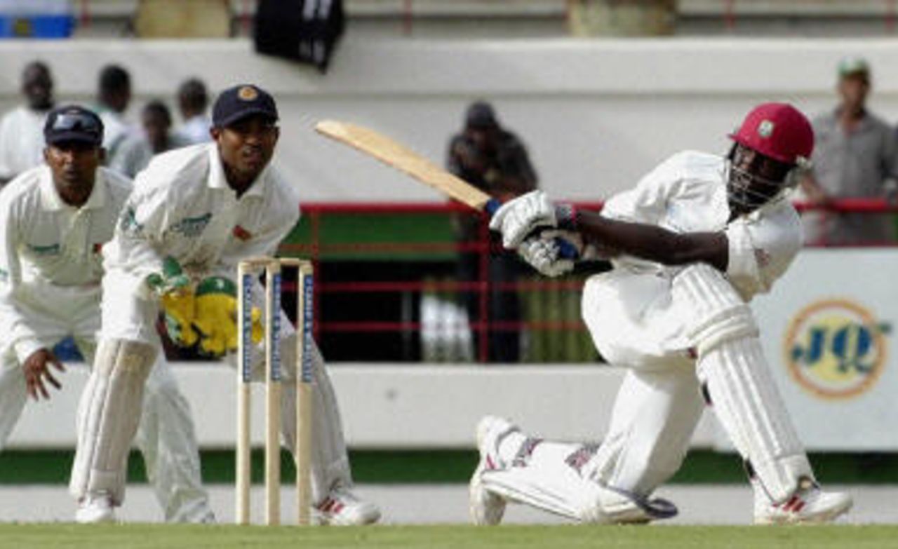 Brian Lara sweeps as Kaluwitharana looks on during the first Test against West Indies at St Lucia.