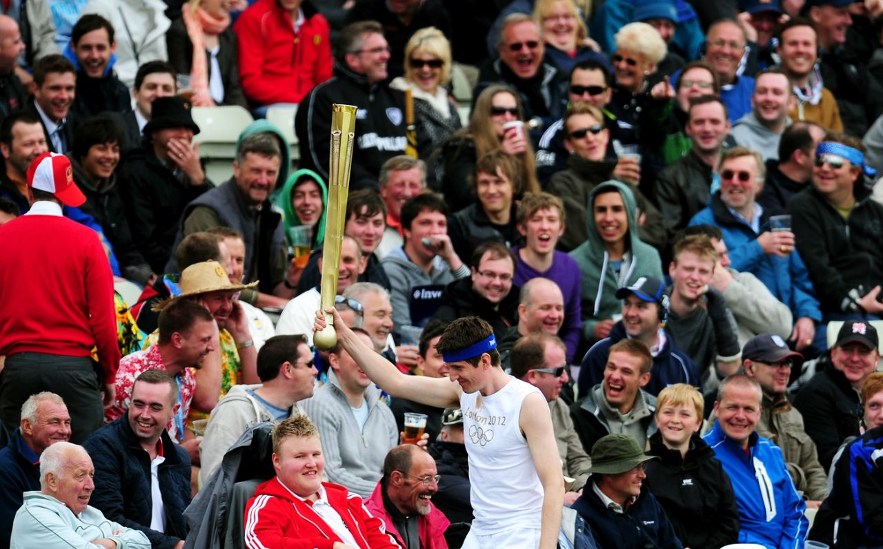 A fan dressed as an Olympic torchbearer walks through the stand, England v West Indies, 3rd Test, Edgbaston, 4th day, June 10, 2012