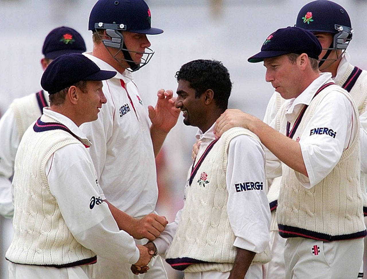 Muttiah Muralitharan celebrates a wicket with his Lancashire team-mates, Blackpool, July 15, 1999