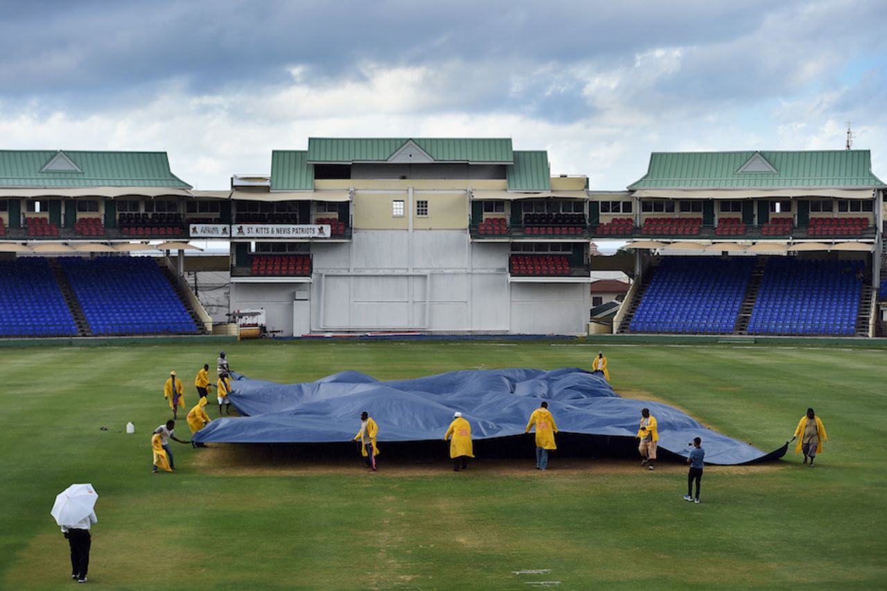 Groundsmen cover the pitch at Warner Park, WICB President's XI v Indians, Basseterre, 1st day, July 14, 2016