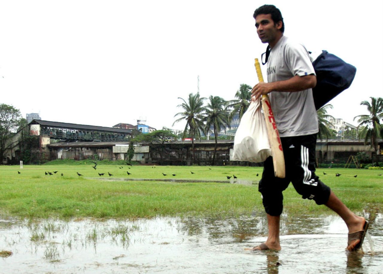 Zaheer Khan walks across a water-logged Parsi Gymkhana in Mumbai