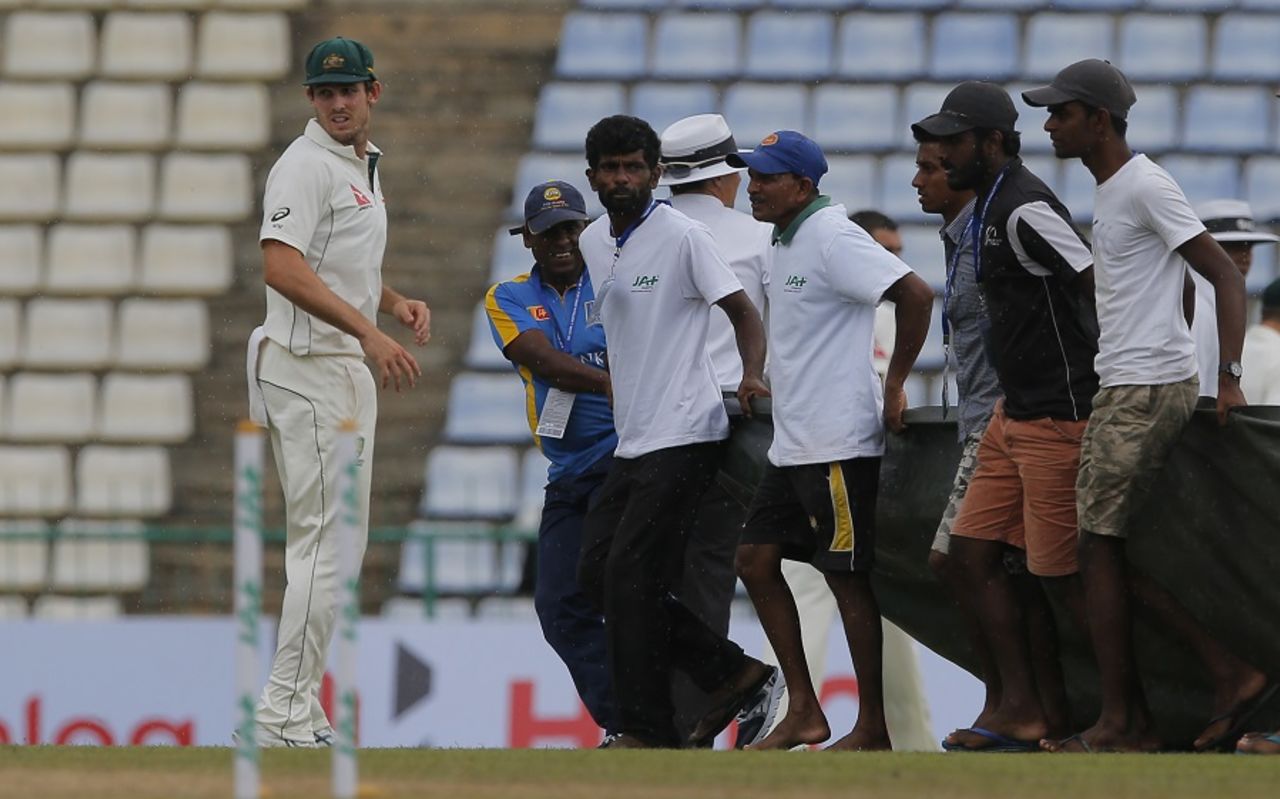Mitchell Marsh walks off as the groundsmen bring the covers on, Sri Lanka v Australia, 1st Test, Pallekele, 2nd day, July 27, 2016