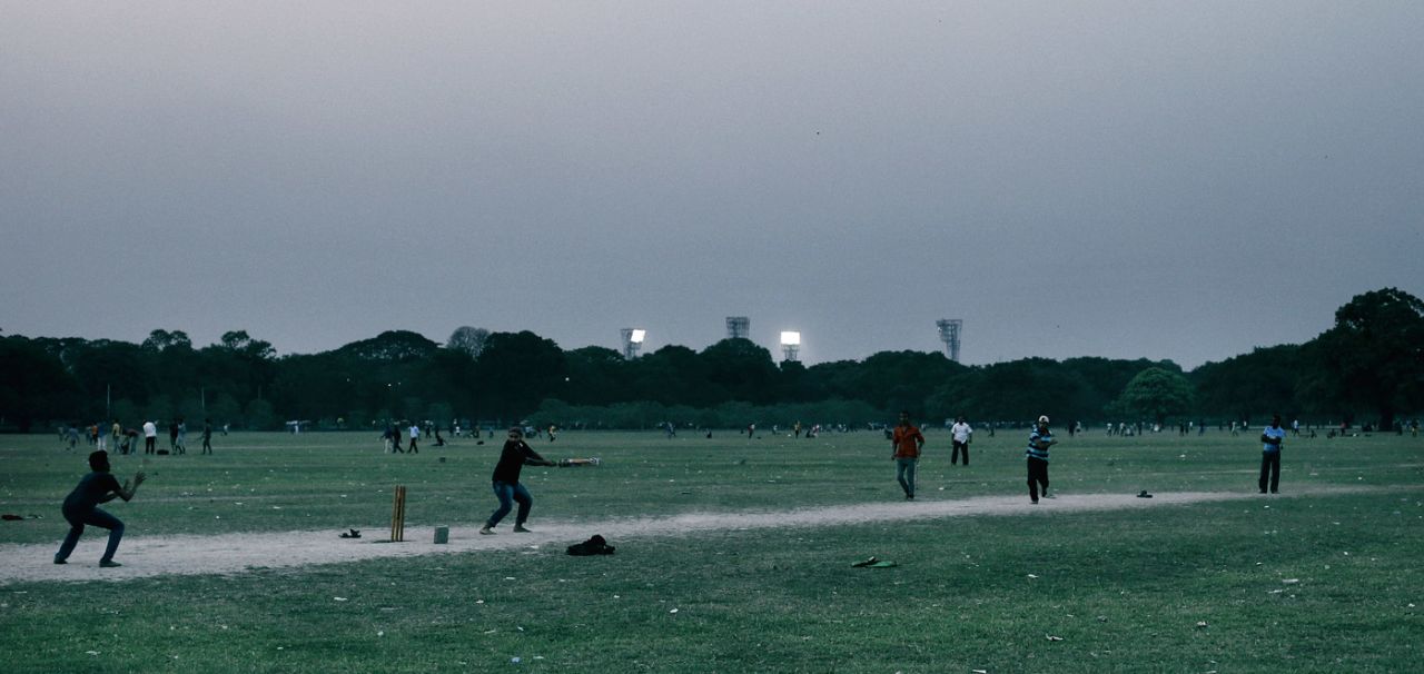 People play cricket at the Kolkata Maidan, April 2, 2016