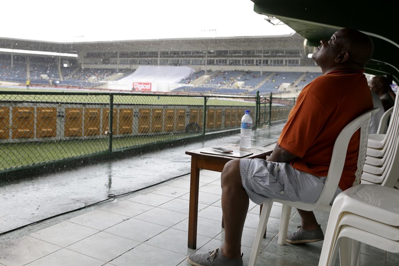 A fan watches the rain fall at Sabina Park, West Indies v India, 2nd Test, Kingston, 3rd day, August 1, 2016