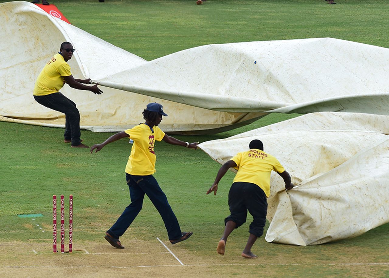 Ground staff at Sabina Park rush to cover the pitch during a spell of rain, West Indies v India, 2nd Test, Kingston, 4th day, August 2, 2016