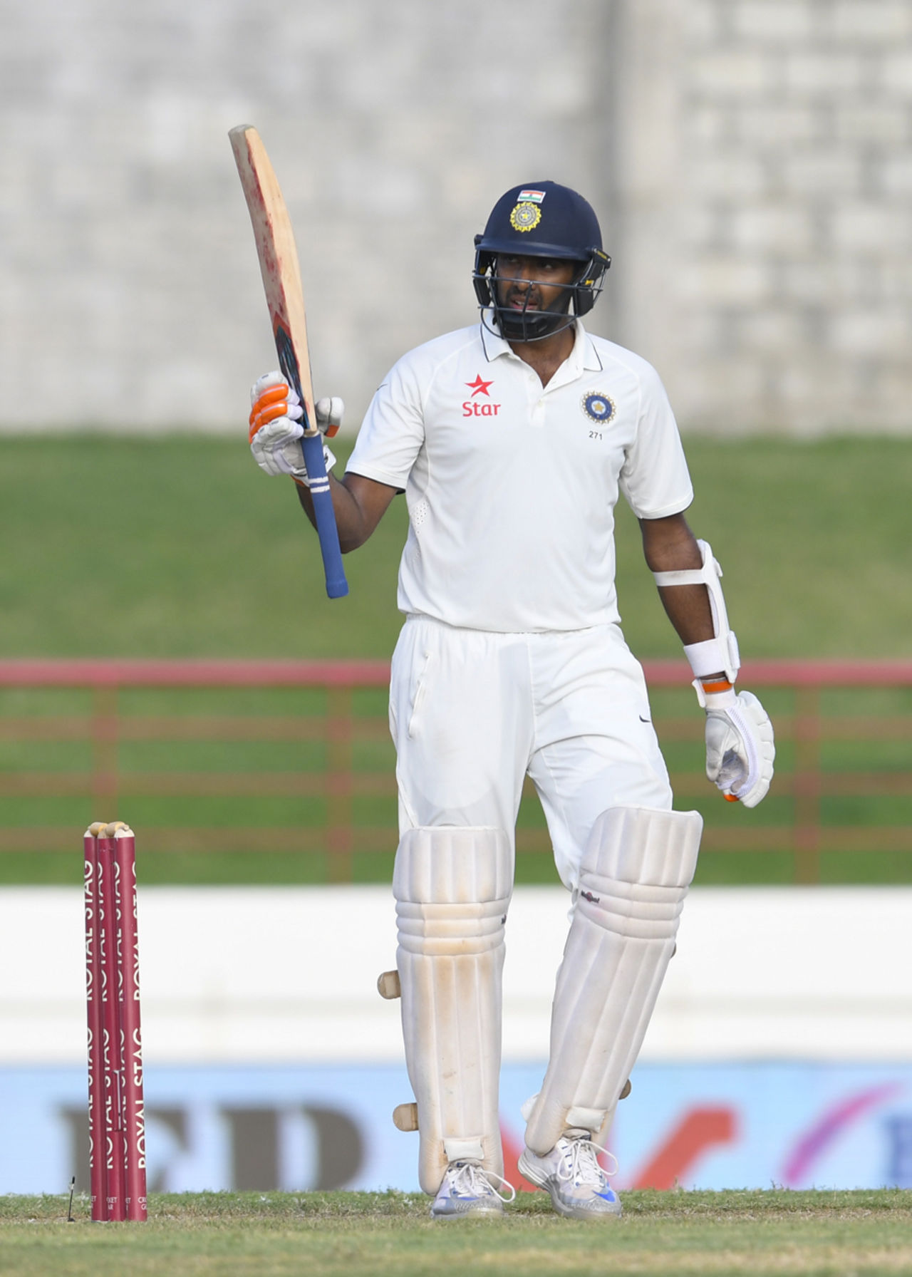 R Ashwin raises his bat after bringing up his fifty, West Indies v India, 3rd Test, Gros Islet, 1st day, August 9, 2016