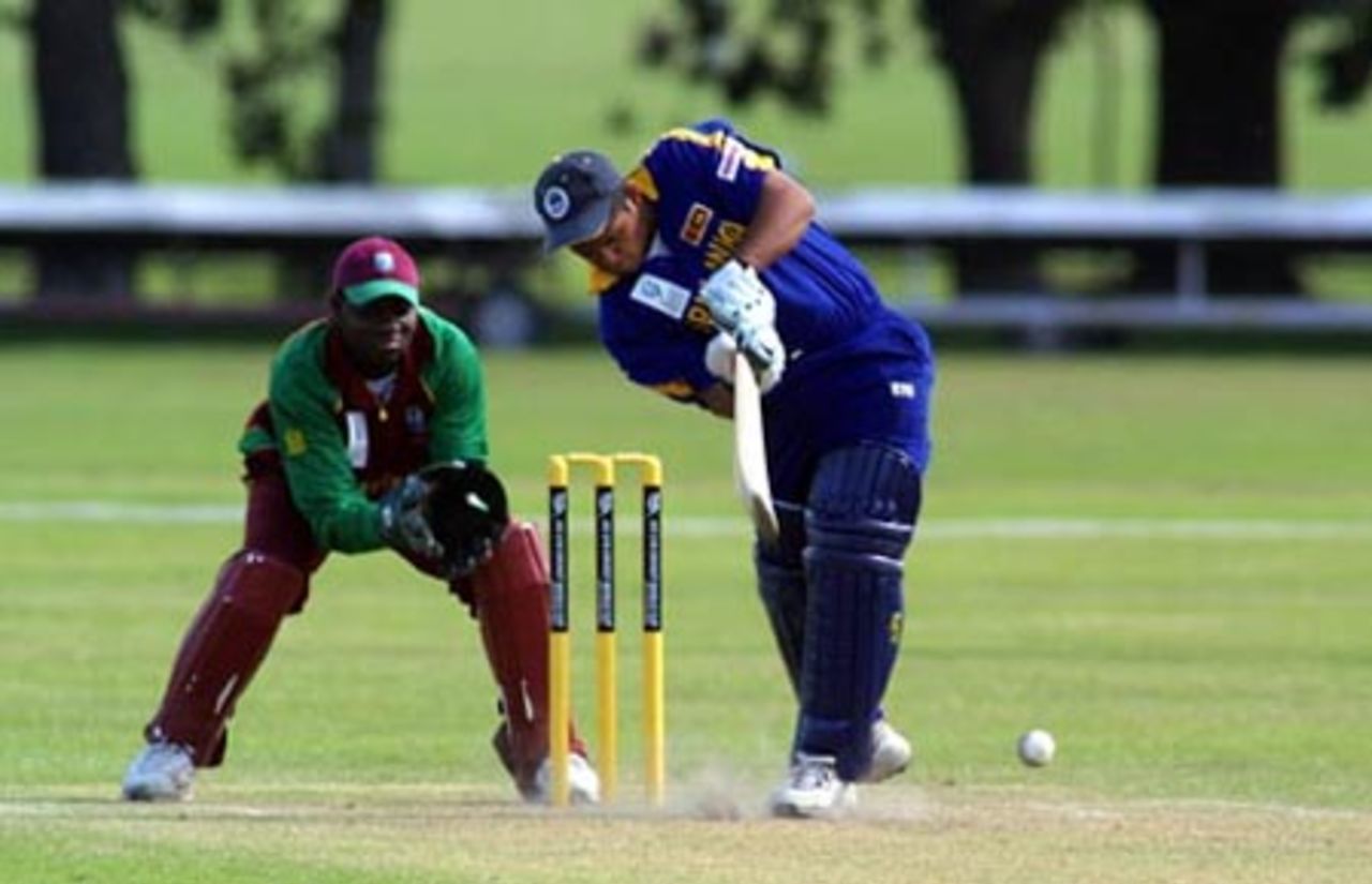 Sri Lanka Under-19 batsman Prasad Ranawaka drives a delivery down the ground on the leg side during his innings of 28. Wicket-keeper Gareth Matthew looks on. ICC Under-19 World Cup Super League Group 1: Sri Lanka Under-19s v West Indies Under-19s at Hagley Oval, Christchurch, 31 January 2002.
