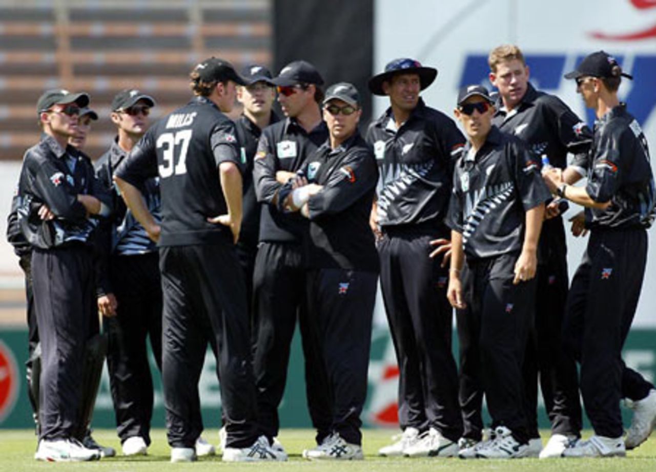 Members of the New Zealand team gather after the dismissal of Indian batsman Mohammad Kaif. From left: Lou Vincent, Brendon McCullum (partially obscured), Nathan Astle, Kyle Mills, Daniel Vettori, Stephen Fleming, Craig McMillan, Daryl Tuffey, Mathew Sinclair, Jacob Oram and 12th man Michael Mason. 3rd ODI: New Zealand v India at Jade Stadium, Christchurch, 1 January 2003.