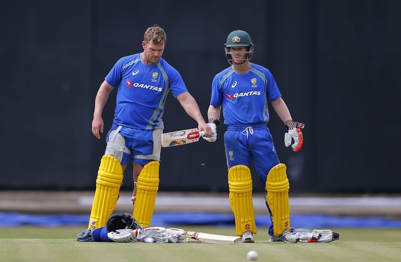 Kaboom: Aaron Finch examines David Warner's bat at a practice session, Colombo, August 19, 2016