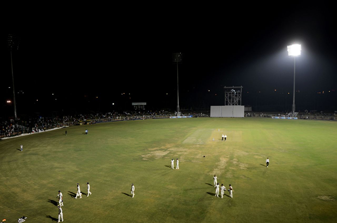 Players walk off the field after a floodlight tower stopped functioning, India Green v India Red, Duleep Trophy 2016-17, 1st day, Greater Noida, August 23, 2016