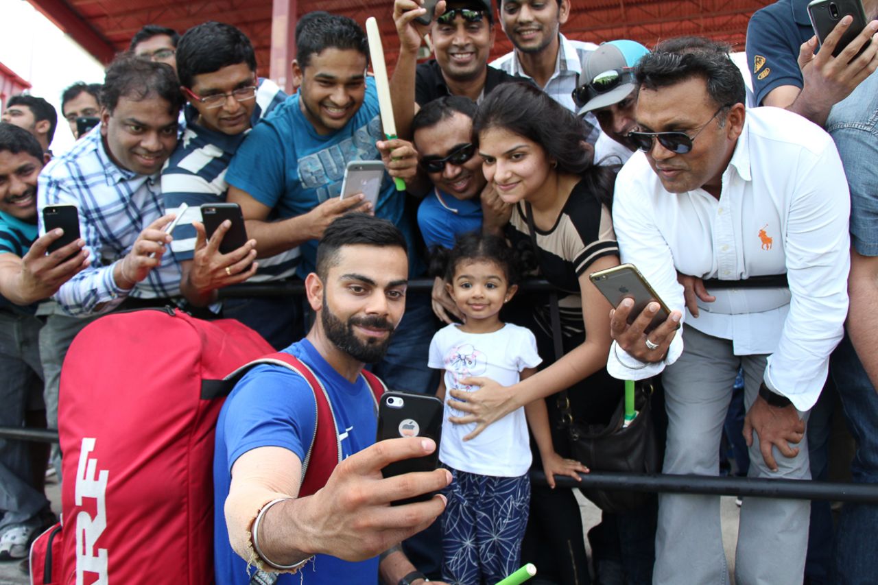 Virat Kohli takes a selfie with a young family after India's training session, Lauderhill, August 26, 2016
