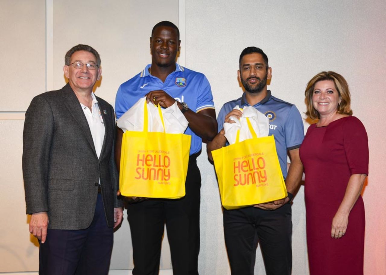 Carlos Brathwaite and MS Dhoni receive gift bags at a welcome reception in Florida, Fort Lauderdale, August 26, 2016