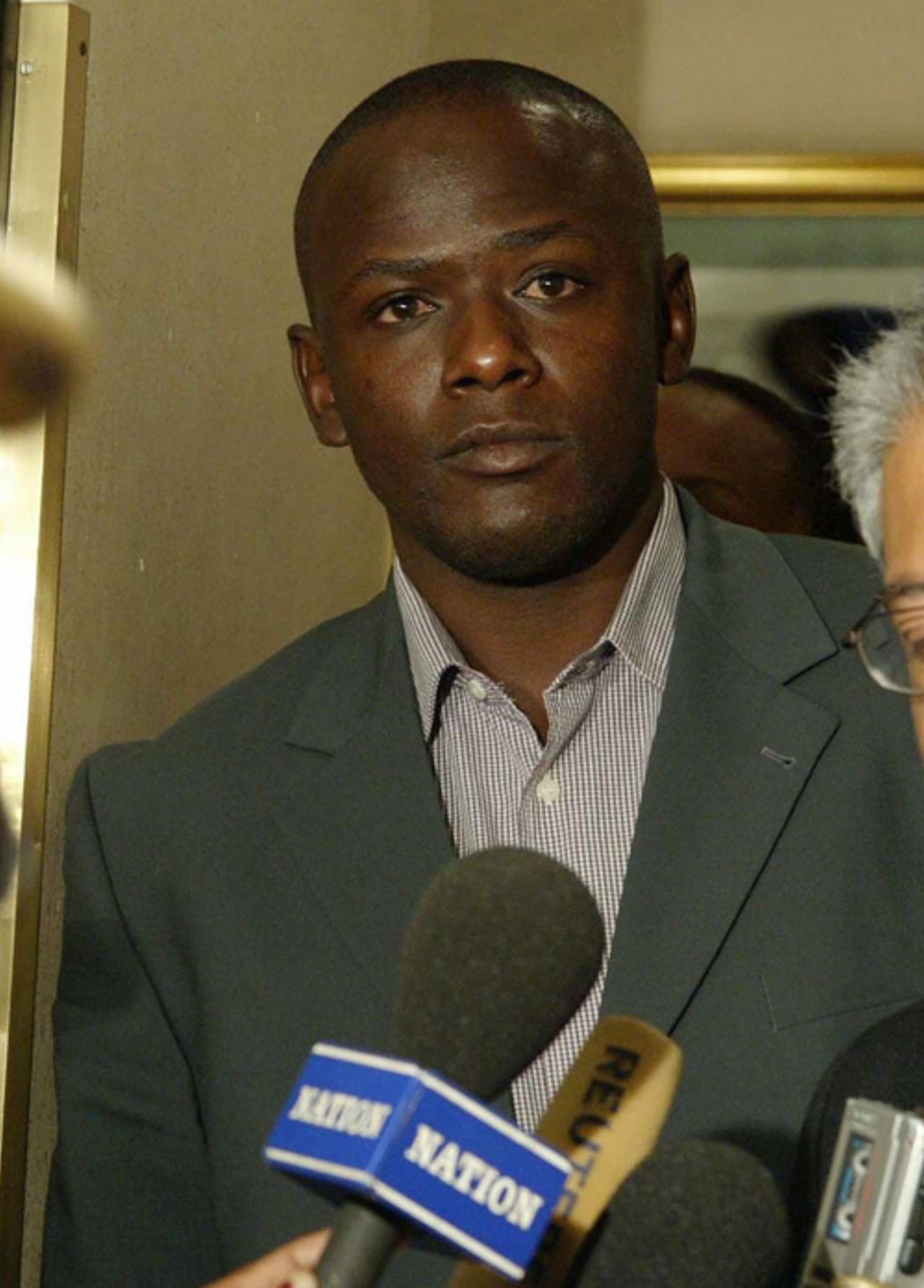 Maurice Odumbe and his lawyer in court, June 19, 2004