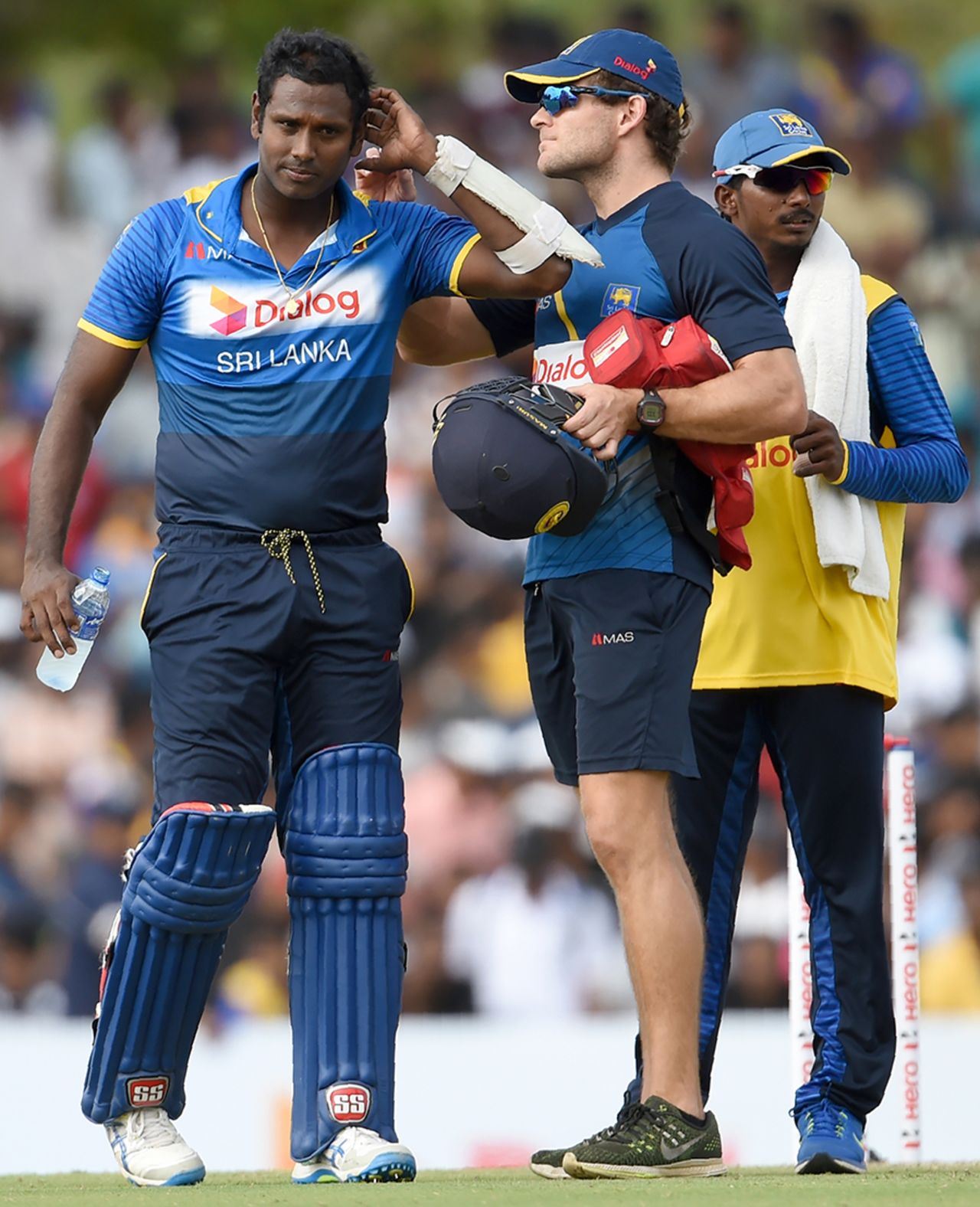 Sri Lanka's physiotherapist checks on Angelo Mathews who was struck on his helmet, Sri Lanka v Australia, 4th ODI, Dambulla, August 31, 2016