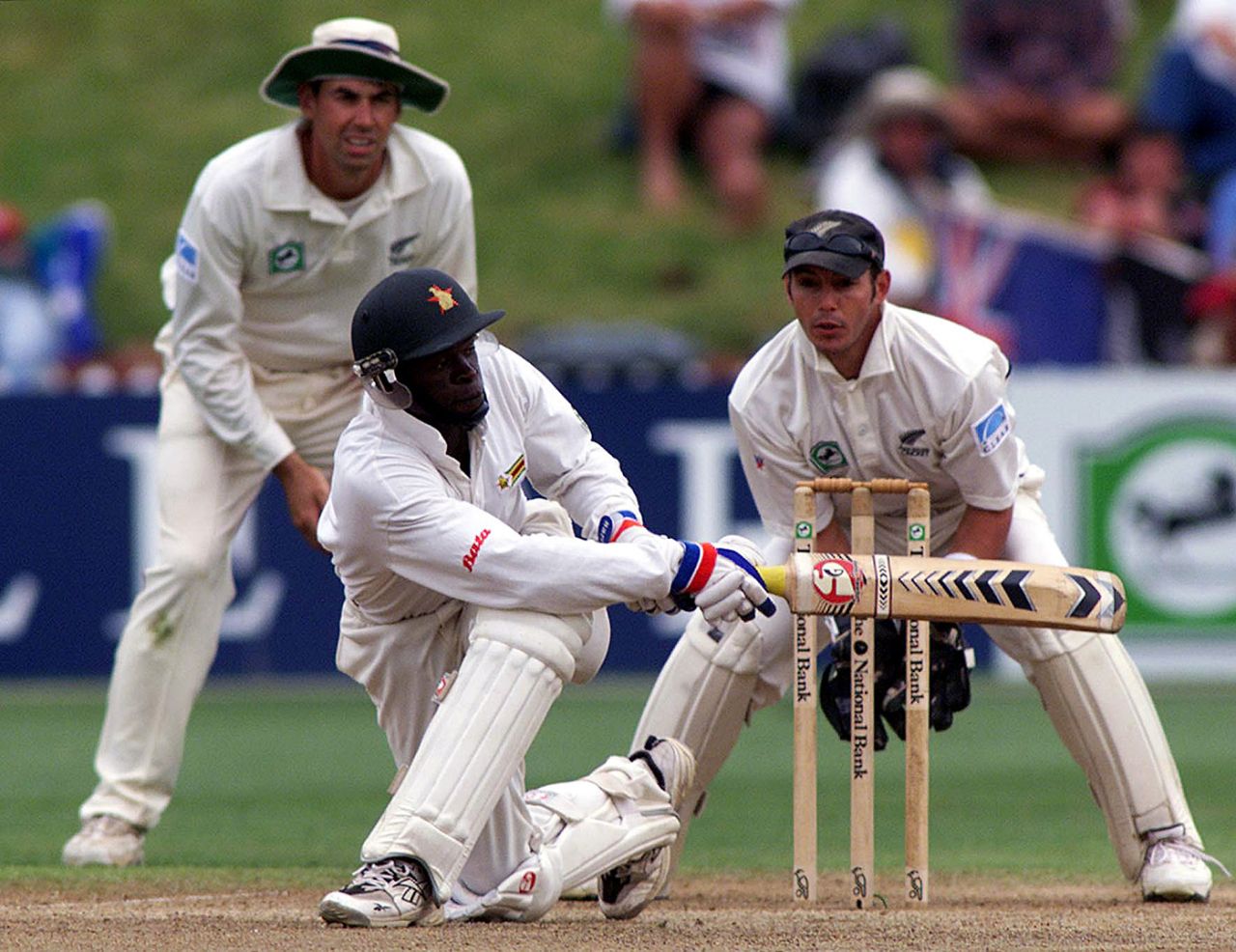 Trevor Madondo sweeps during his 74, New Zealand v Zimbabwe, Only Test, Wellington, 4th day, December 29, 2000