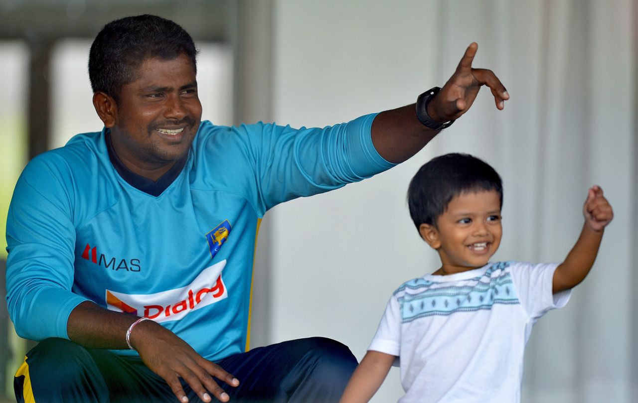 Rangana Herath with his son, Galle, August 3, 2014