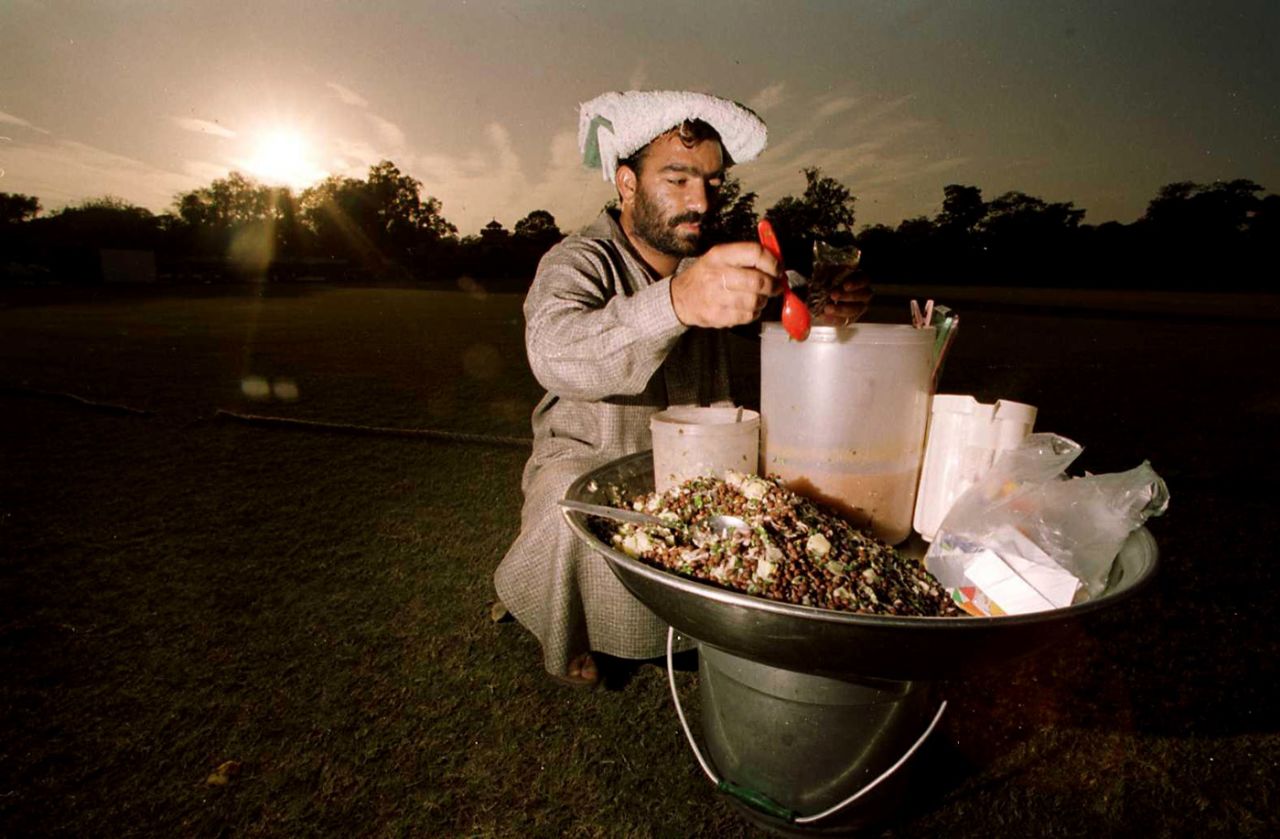 A food seller doles out beans and rice by the boundary during the tour game, Lahore, November 25, 2000