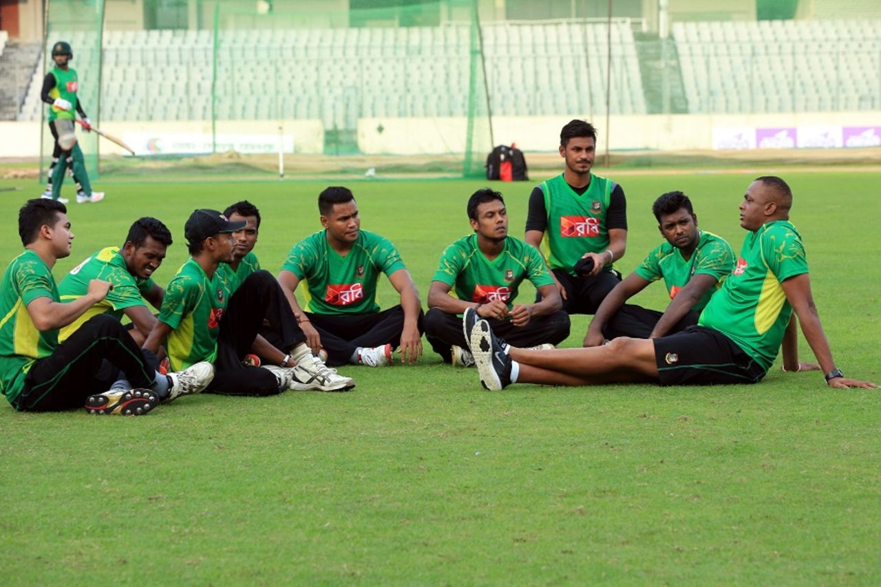 A group of pace bowlers keenly listen as Courtney Walsh addresses them during a training session, Mirpur, September 20, 2016